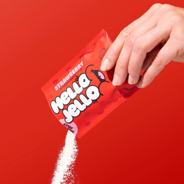 Pouring HELLO JELLO Strawberry jelly crystals from the sachet
